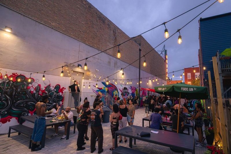 Guests enjoying an outdoor event in a colorful Chicago beer garden