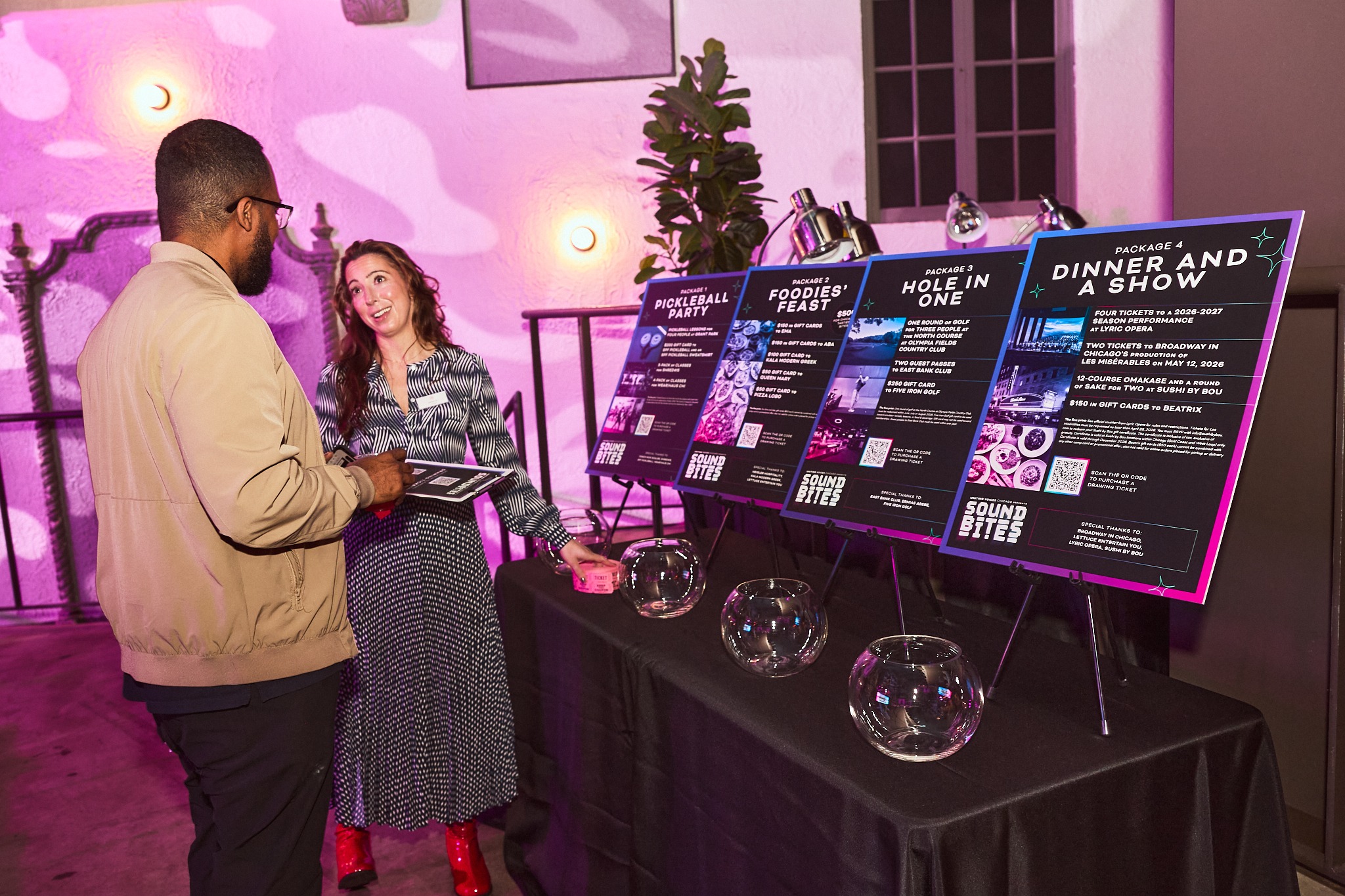 Guests reviewing event auction packages at a professionally produced fundraiser