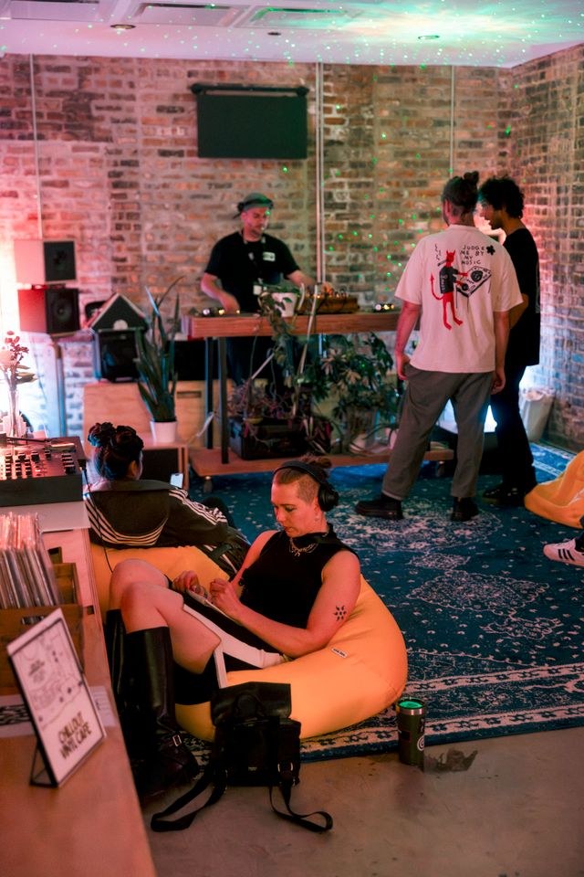 Guests relaxing in a private event lounge with a DJ and vinyl records